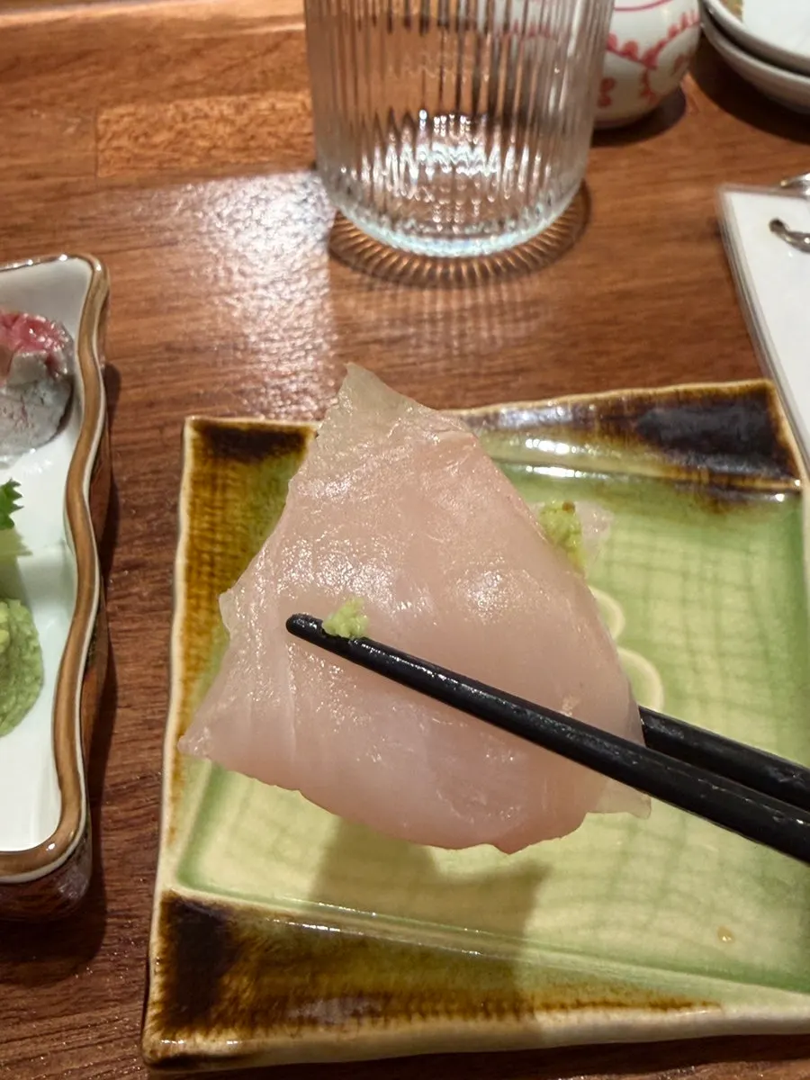 Scallop sashimi topped with wasabi