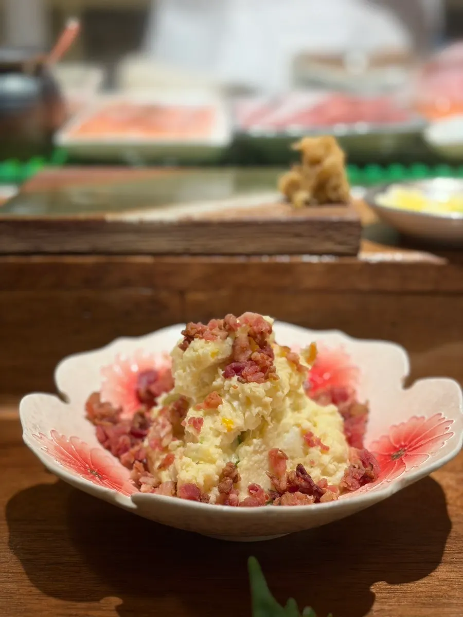 Potato salad topped with bacon bits