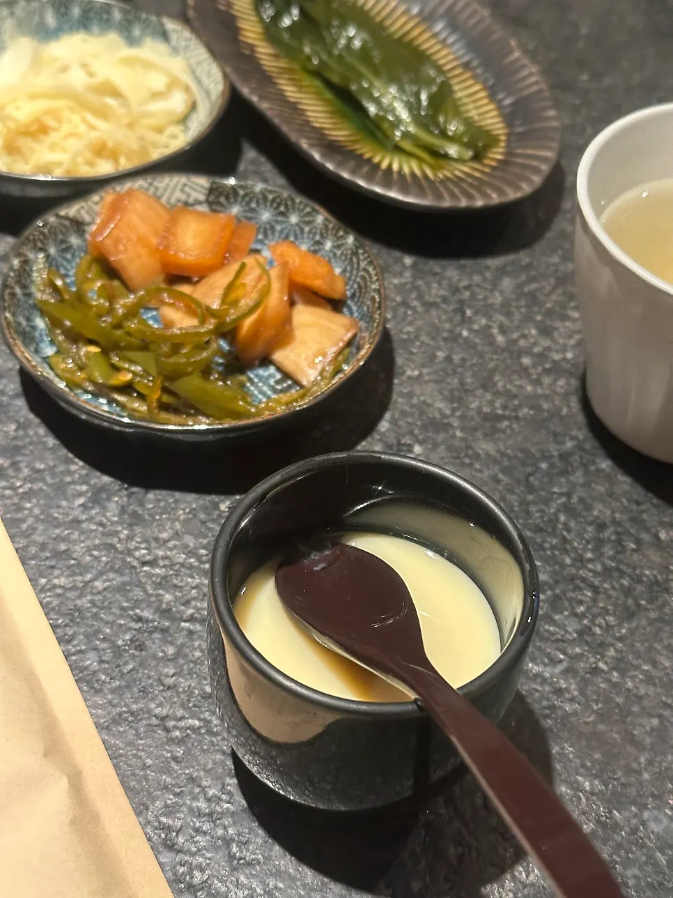 Side dishes set on the table at Manmok