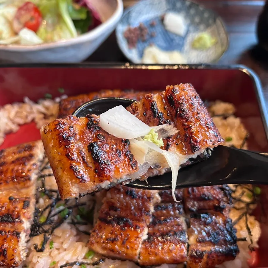A piece of eel topped with wasabi and ginger