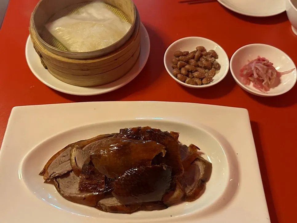 A full table setting of Peking duck and accompaniments