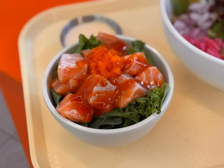 Fire chicken salmon kkakdugi topped with sauce and flying fish roe