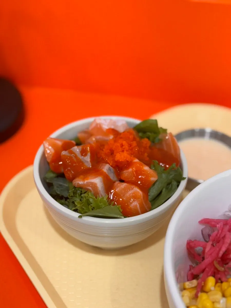 Fire chicken salmon kkakdugi served alongside steak poke