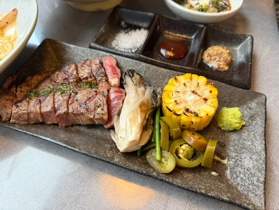Flat iron steak with mushroom, corn, and other garnish
