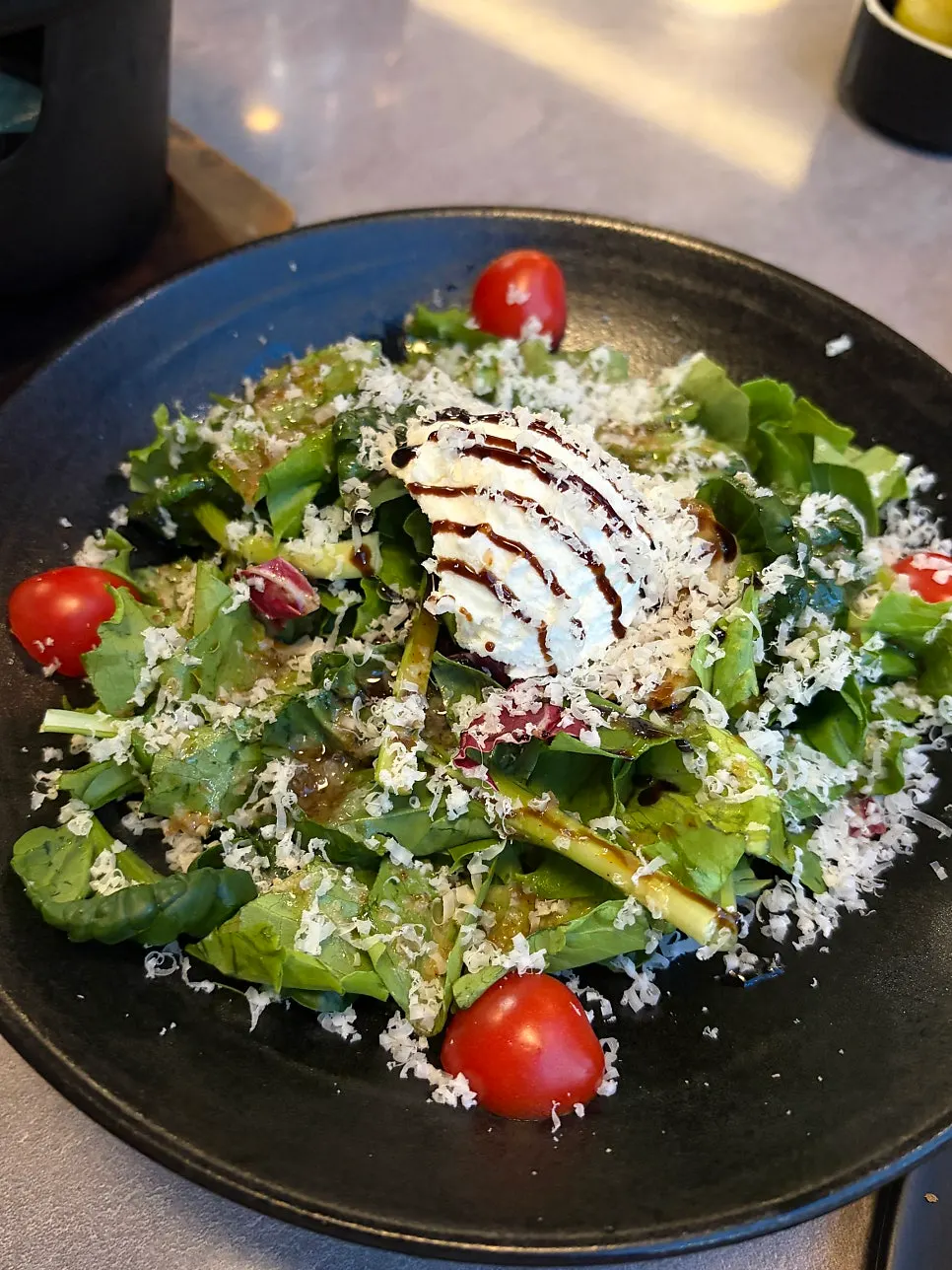 Salad topped with ricotta cheese