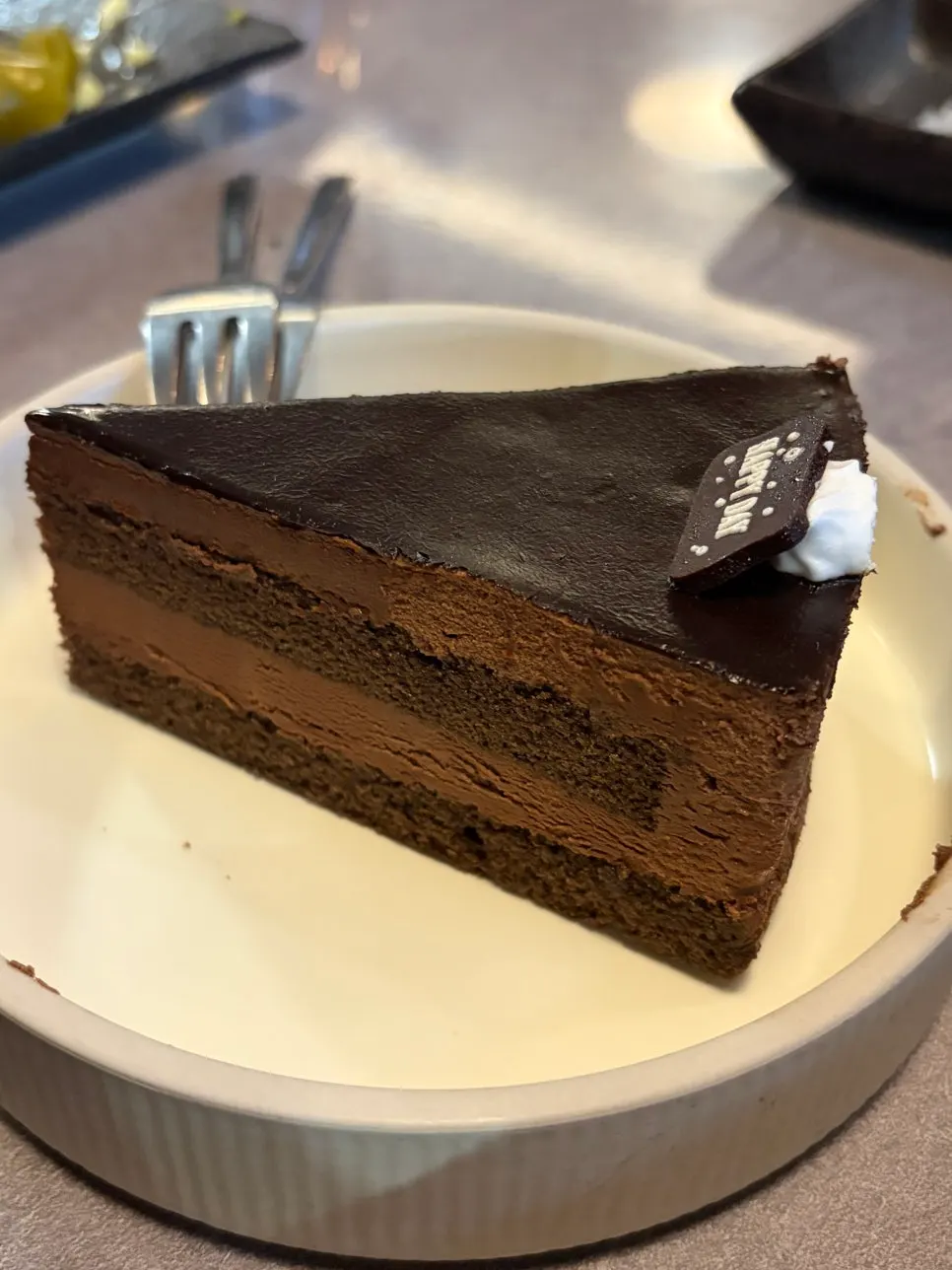 Finishing dessert of chocolate mousse cake