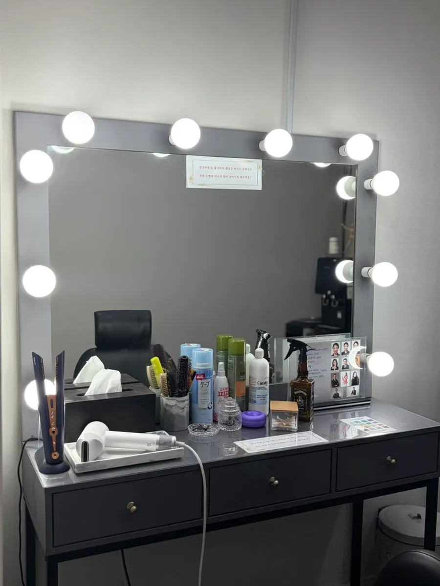 Makeup room with curling iron and hair products organized
