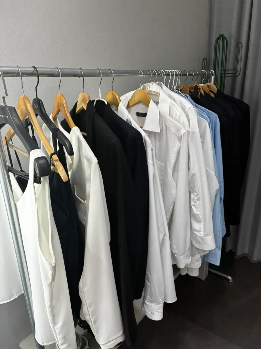 Shirts hung by size in the powder room