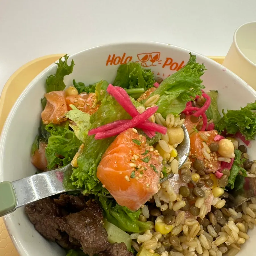 A bowl of raw salmon poke with extra toppings