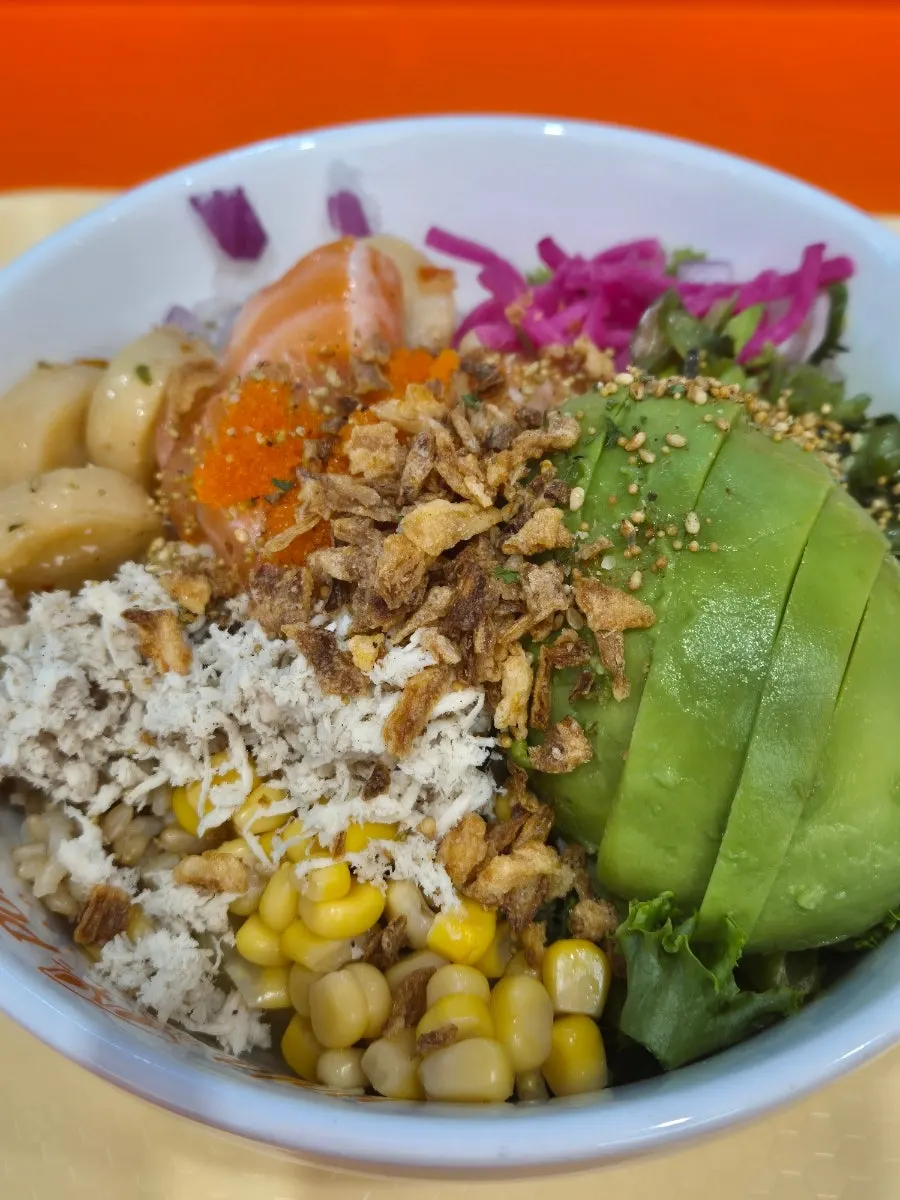 Close-up of the poke bowl topped with half an avocado