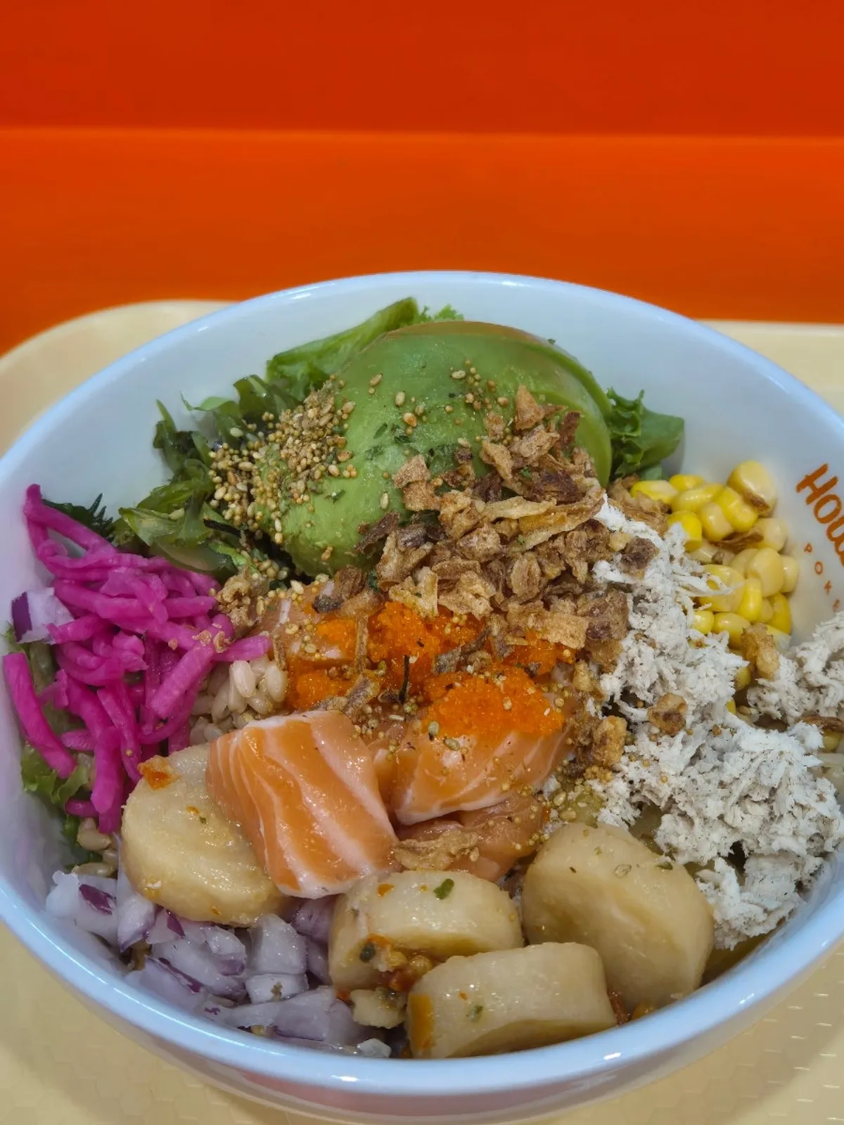 Poke bowl with fresh vegetables and fried onion flakes on top