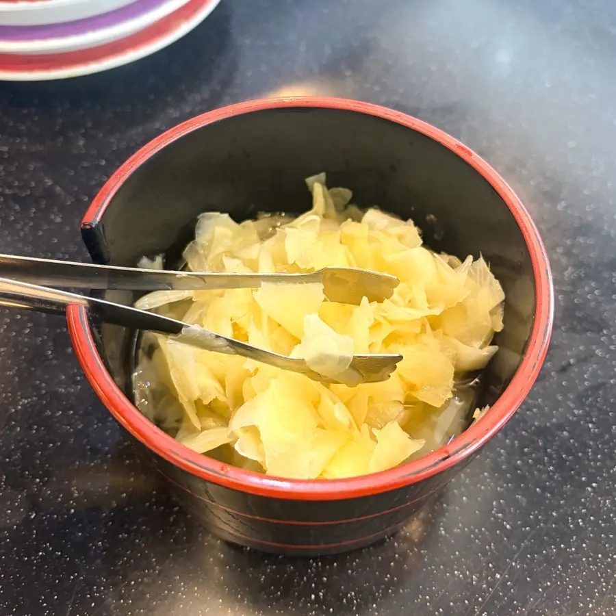 Soy sauce and wasabi served alongside the sushi
