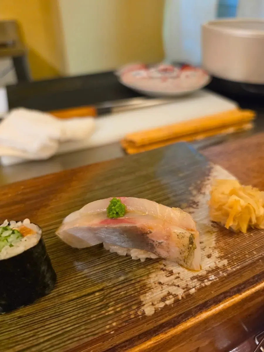 A piece of sushi served at the counter