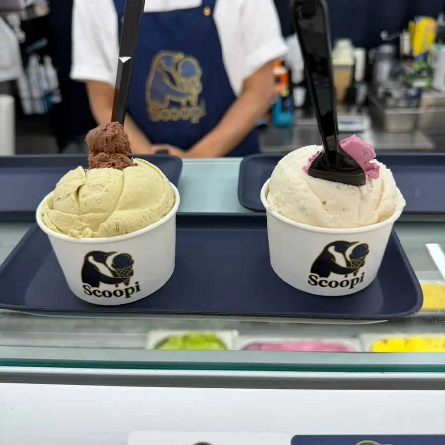 Gelato cup topped with triple berry and chocolate tastes
