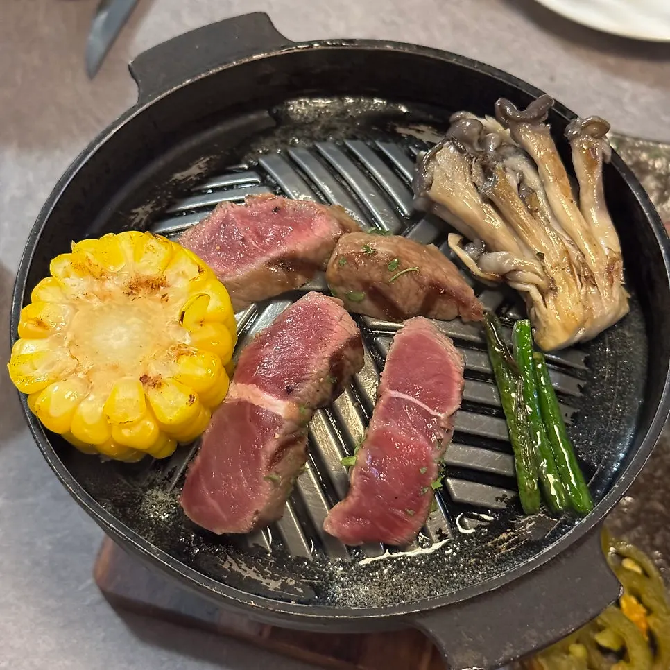 Flat iron steak grilled over a brazier