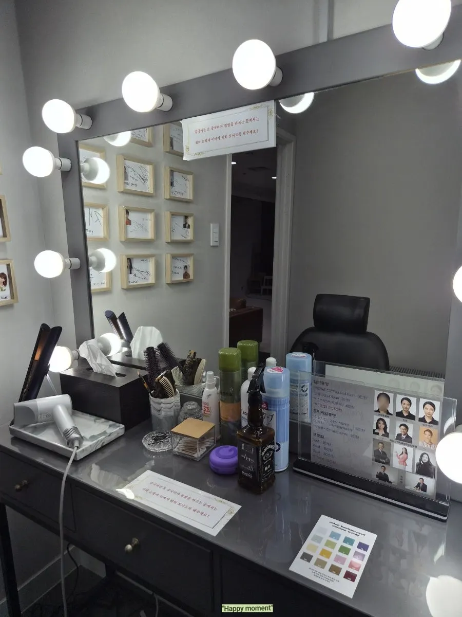 Framed autographed celebrity photos on the studio wall