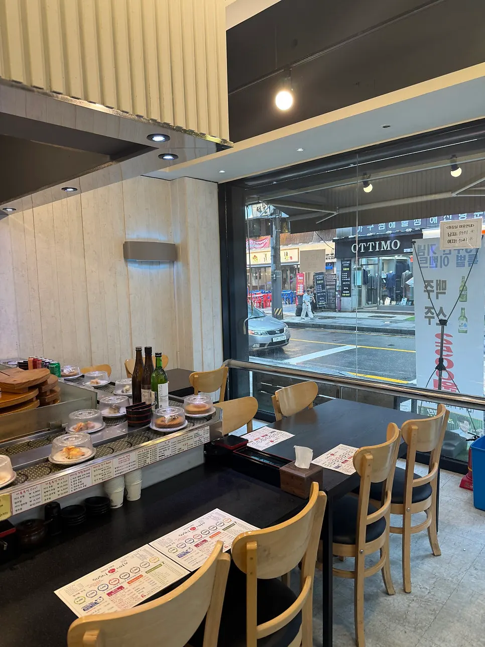 Hall table at the conveyor-belt sushi restaurant with floor-to-ceiling windows