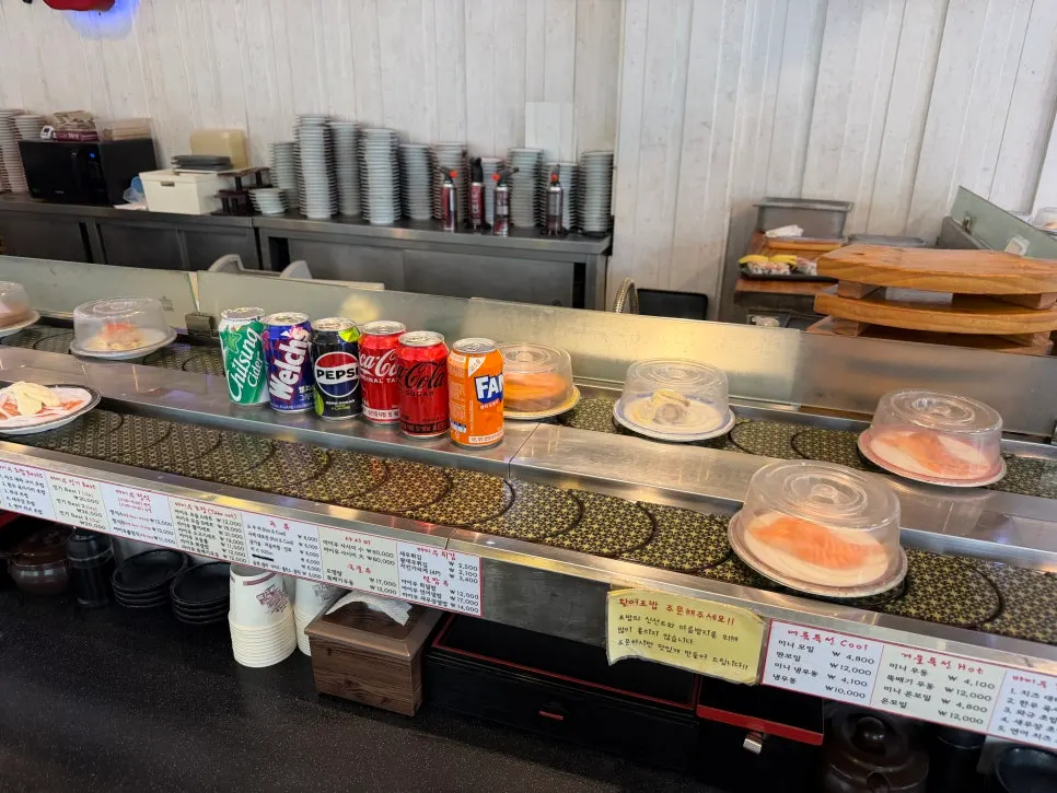 Covered sushi plates circling on the rail