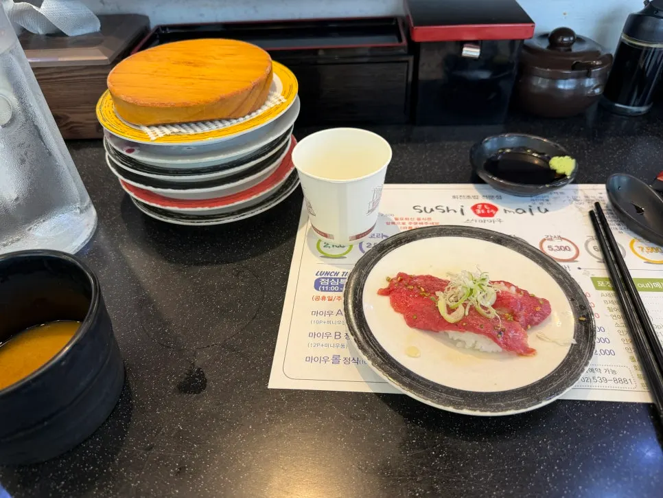 Stacked conveyor-belt sushi plates on the table