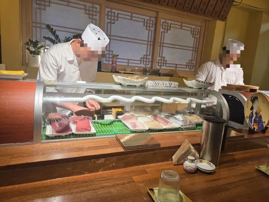 Sakai's bar seats with a view of sushi being made