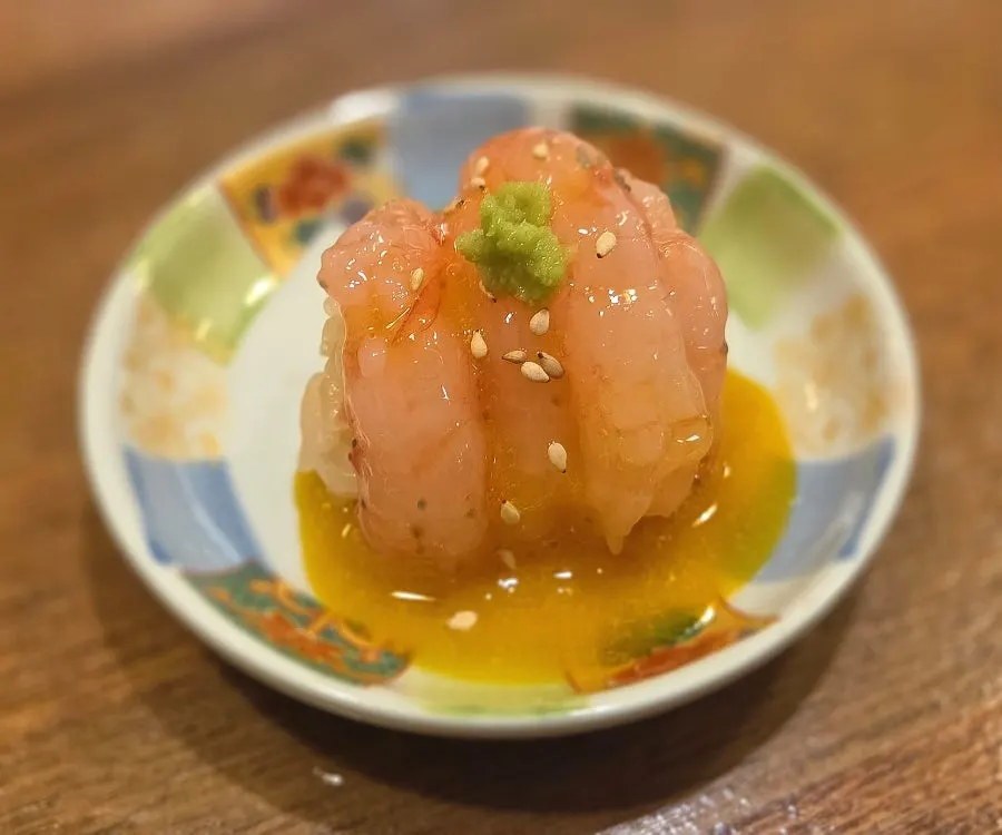 Sweet shrimp nigiri served with egg yolk
