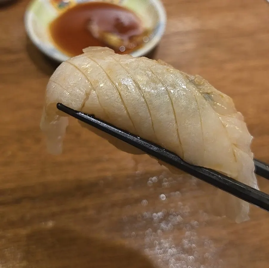 Engawa sushi with careful knife scoring