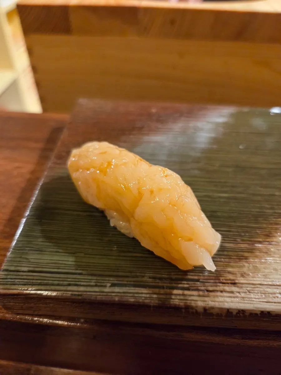 Scallop nigiri tapped with the back of a knife