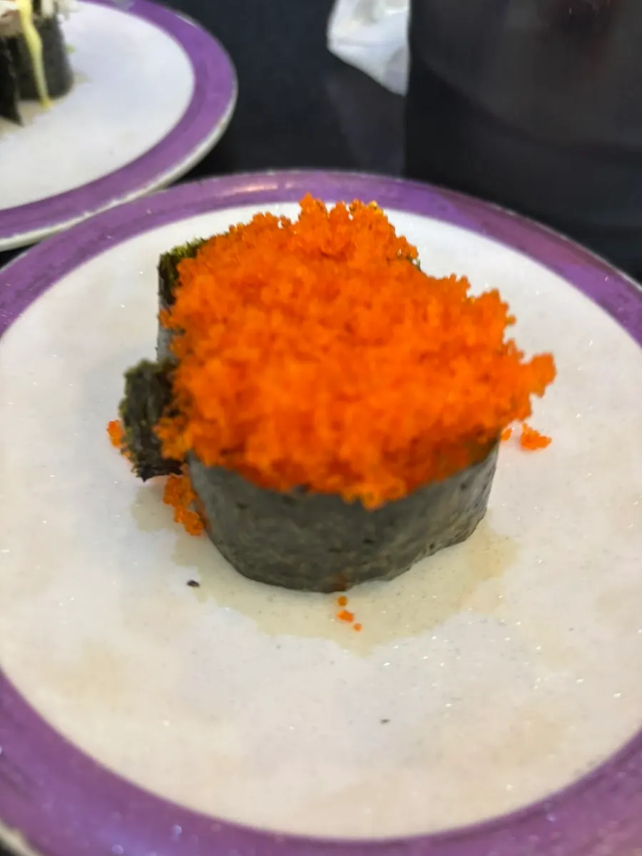 Salmon sushi served with seaweed