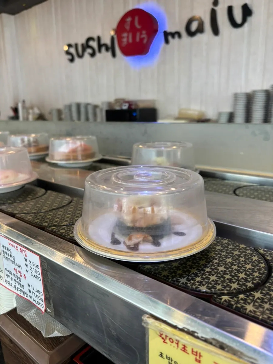 Rolled egg sushi and conveyor-belt sushi meal