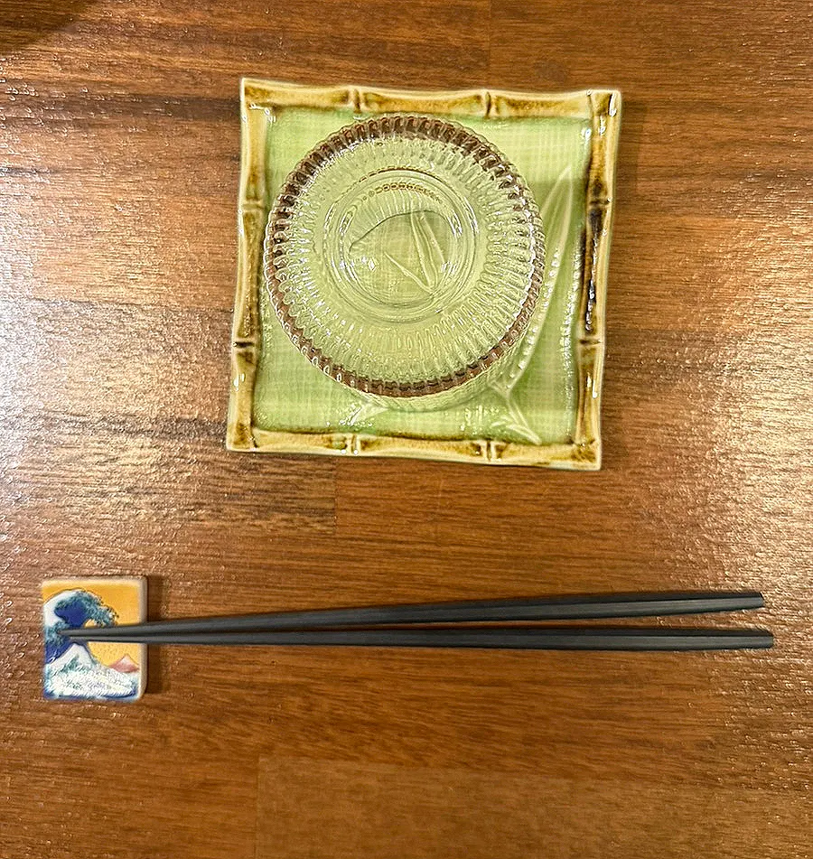 Chopsticks, small plate, and water glass set at the counter seat