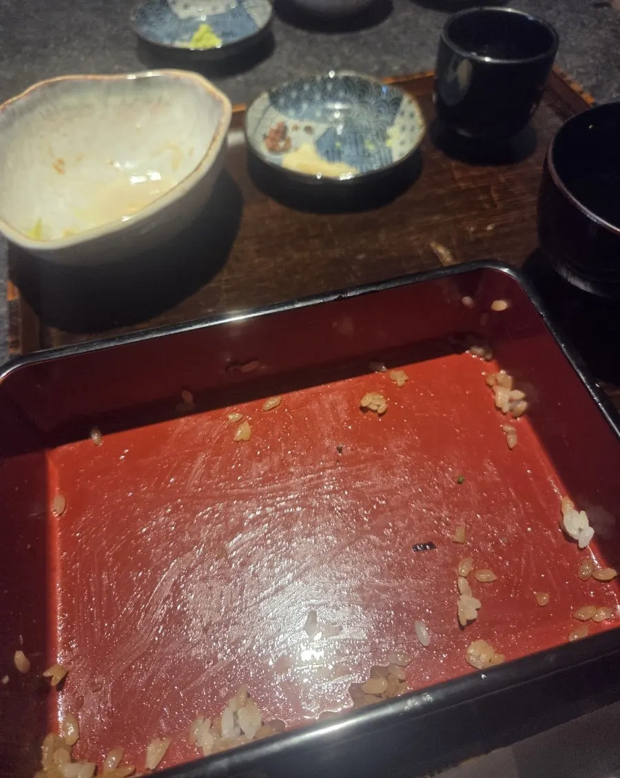 Finishing the eel rice bowl meal