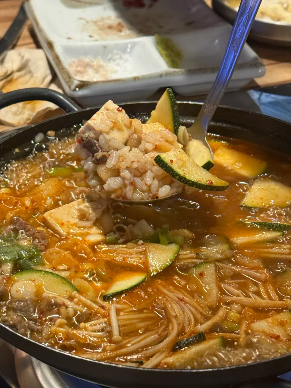 A bowl of doenjang sulbap with enoki mushrooms, zucchini, and meat