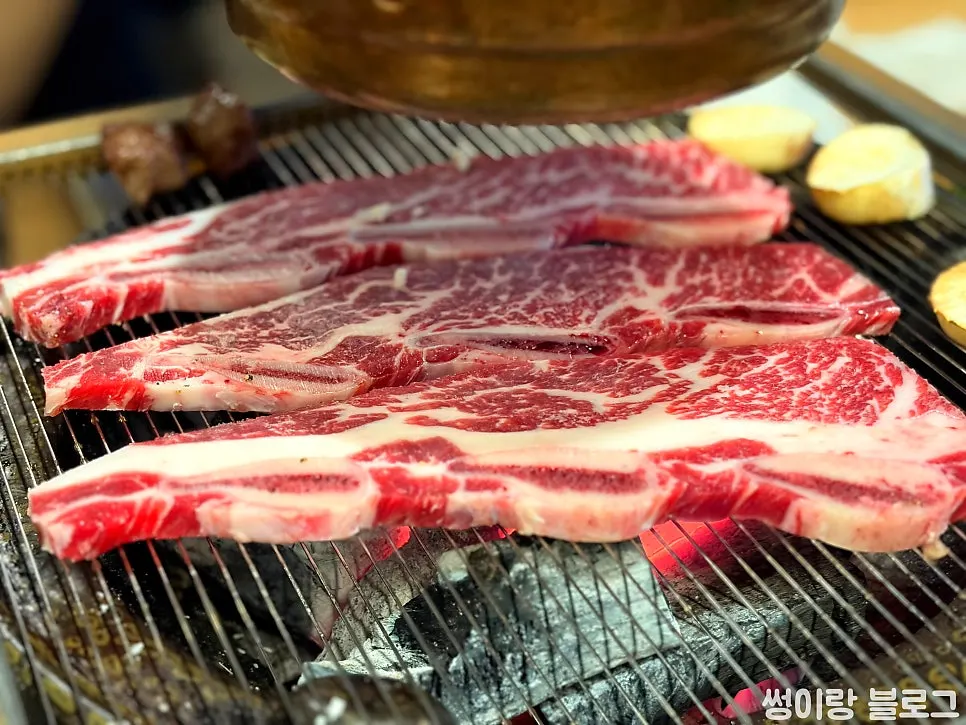 LA-style ribs picking up charcoal aroma on the grill