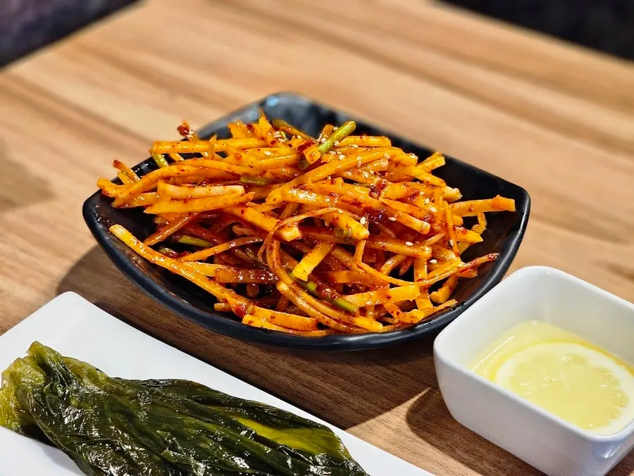 Shredded radish salad and myeongi namul accompaniments