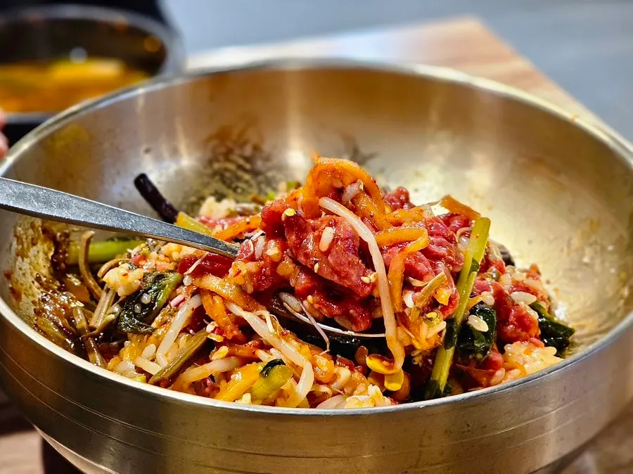 Marinated rib meat and yukhoe bibimbap table spread