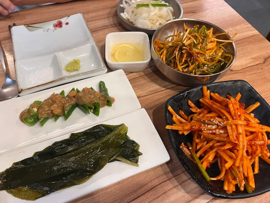 Side dishes including scallion salad and mountain garlic leaves