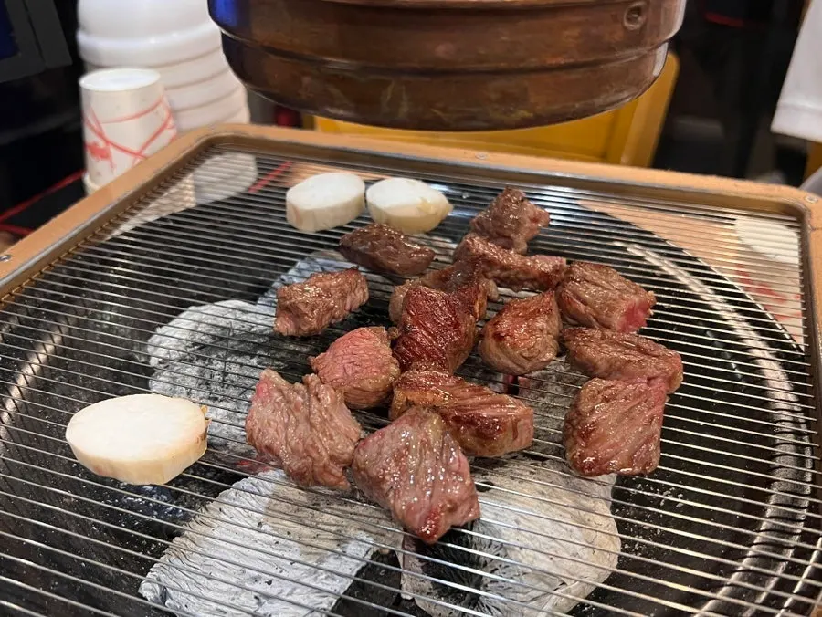 Staff grilling the diced kkotsal