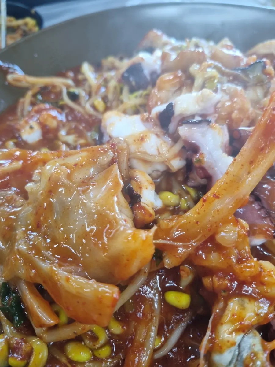 Close-up of bean sprouts and sauce in the monkfish-octopus braise
