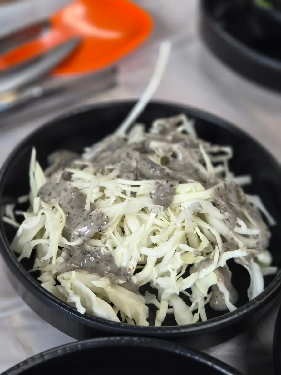 Salad side dish topped with a nutty dressing