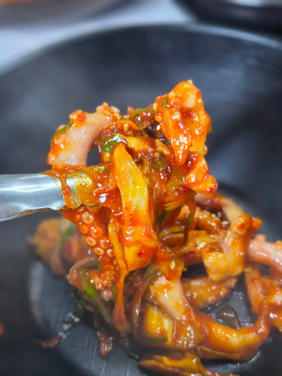 Picking up a piece of plump octopus