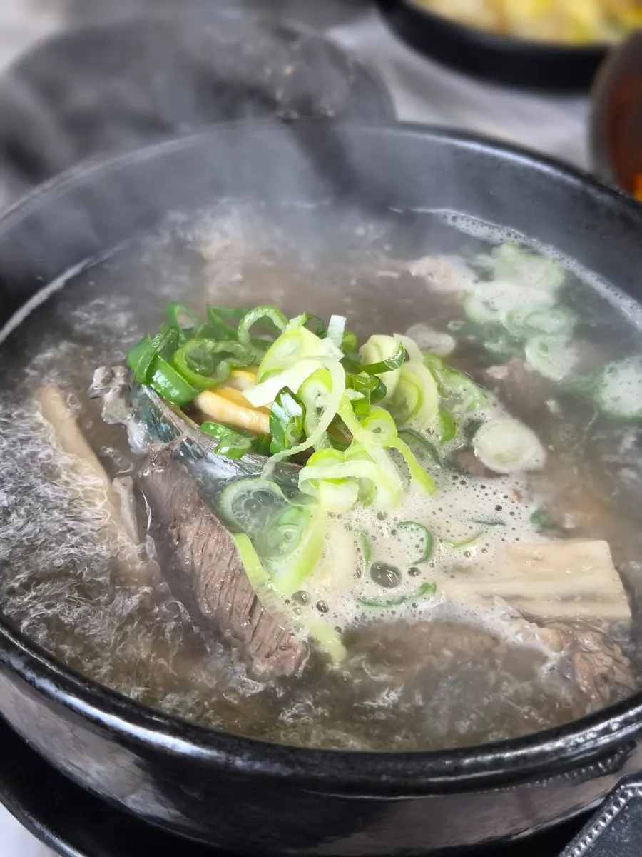 Clear abalone galbitang loaded with green onion
