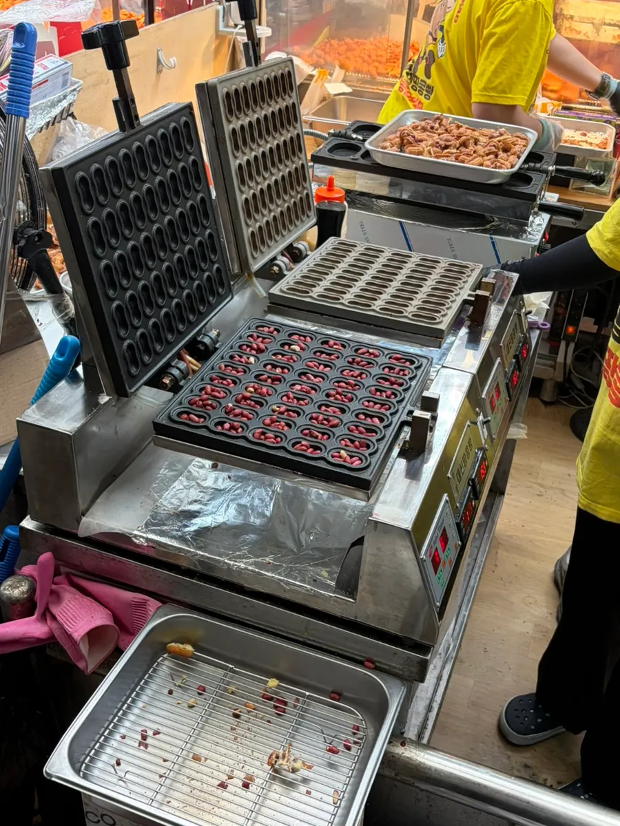 Whole peanuts packed into one slot of the peanut bread mold