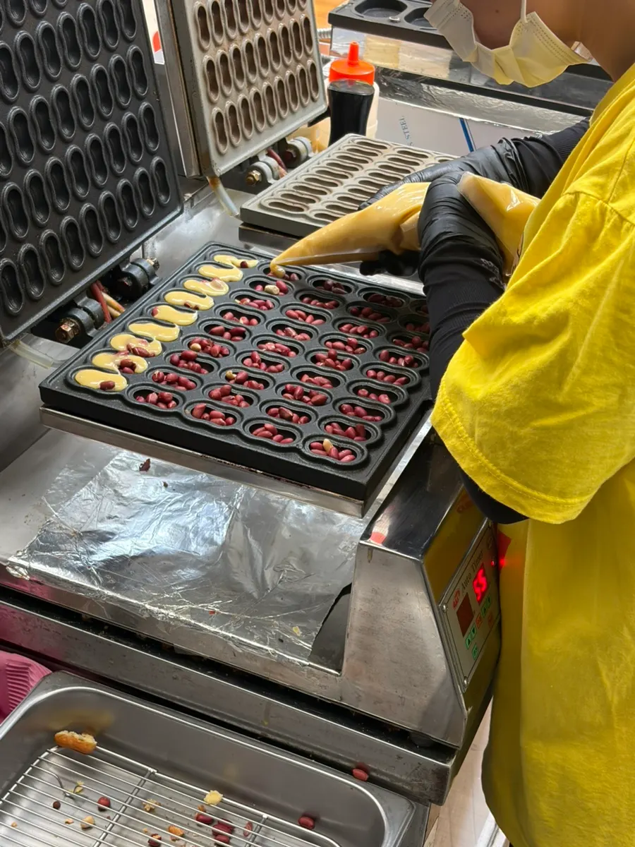 Batter being poured into the peanut bread mold