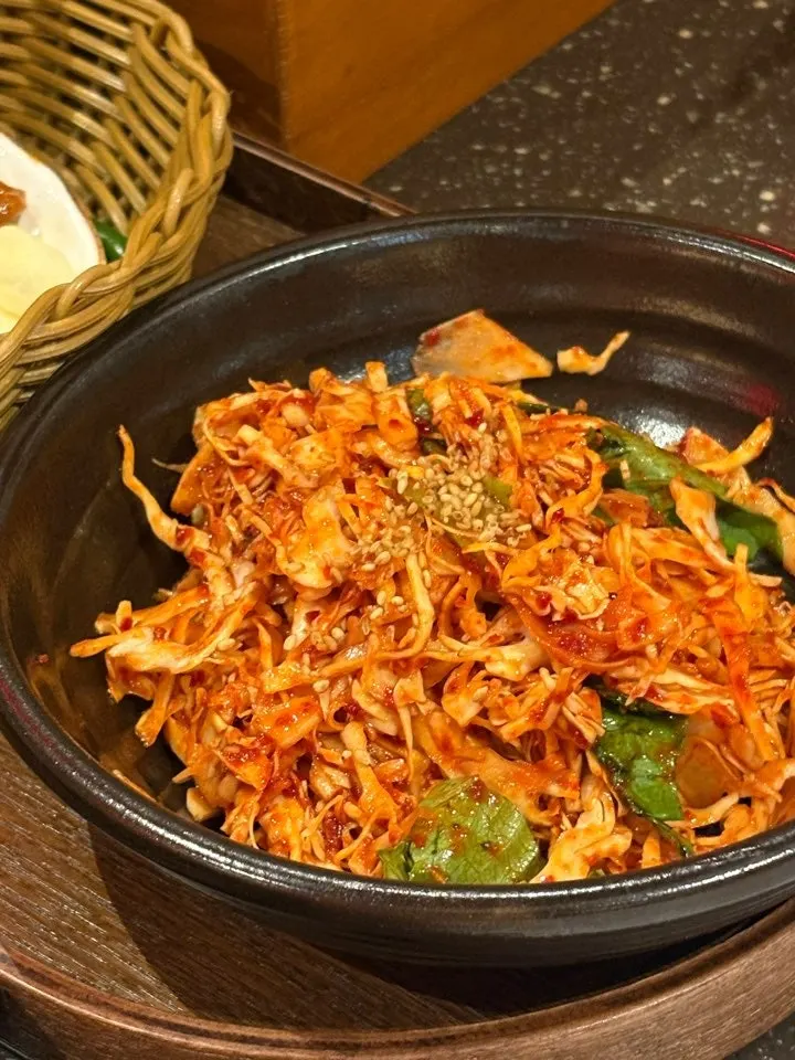 Side dish spread including pickles and fresh kimchi at Anmin Busan