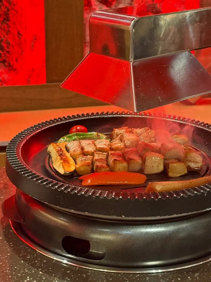 Staff member grilling meat at Anmin Busan