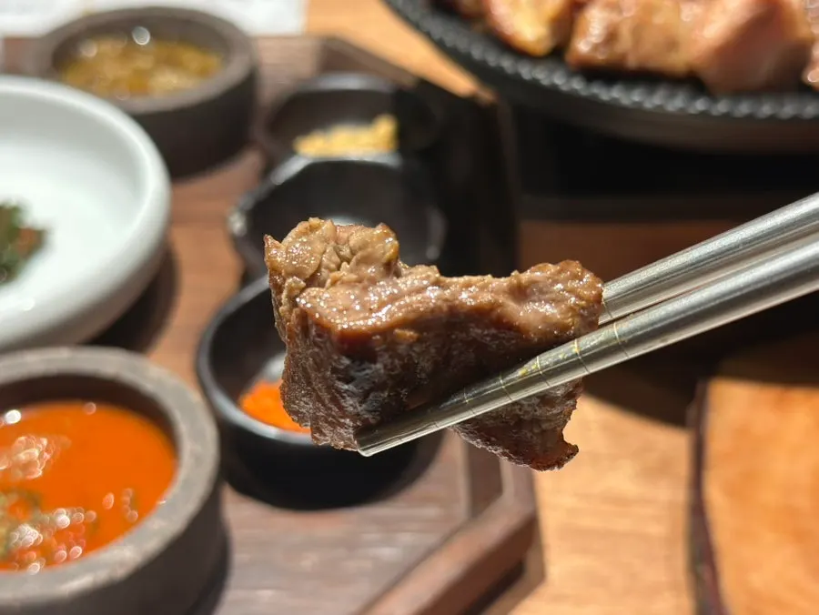 A plate of grilled meat with garnish vegetables