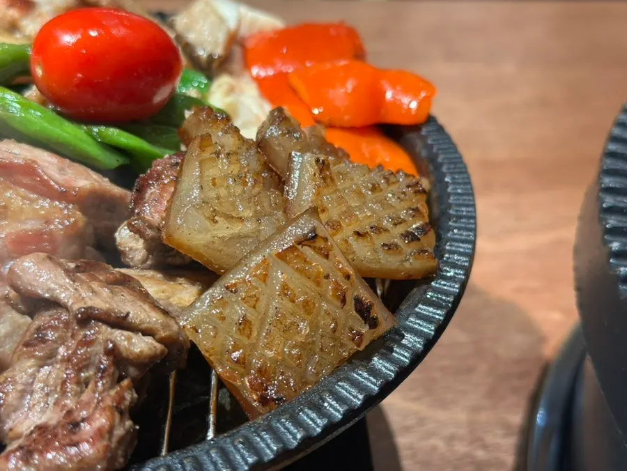 A piece of meat paired with cabbage salad