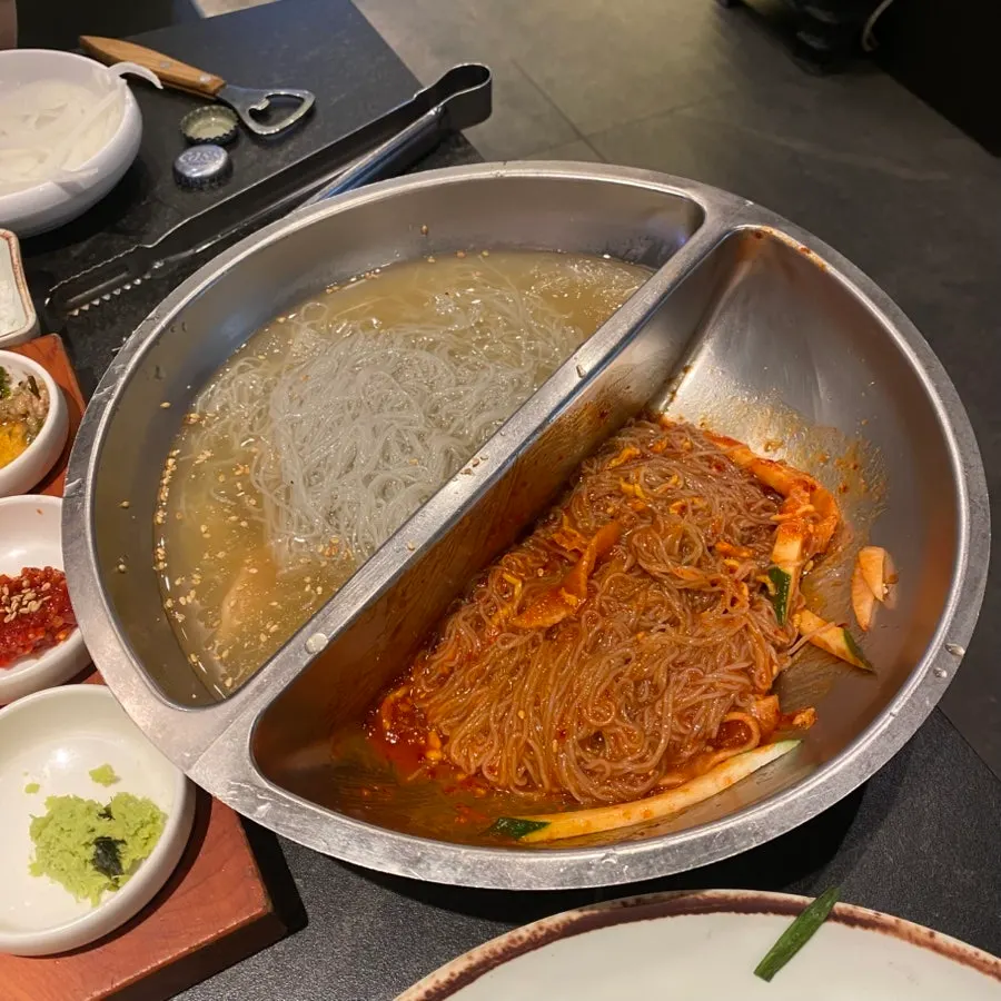 Half-and-half naengmyeon with broth and spicy mixed noodles