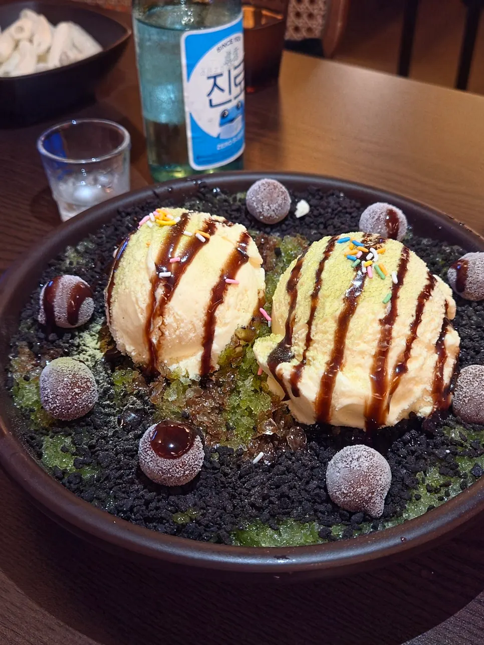 Matcha bingsu topped with ice cream and chocolate toppings
