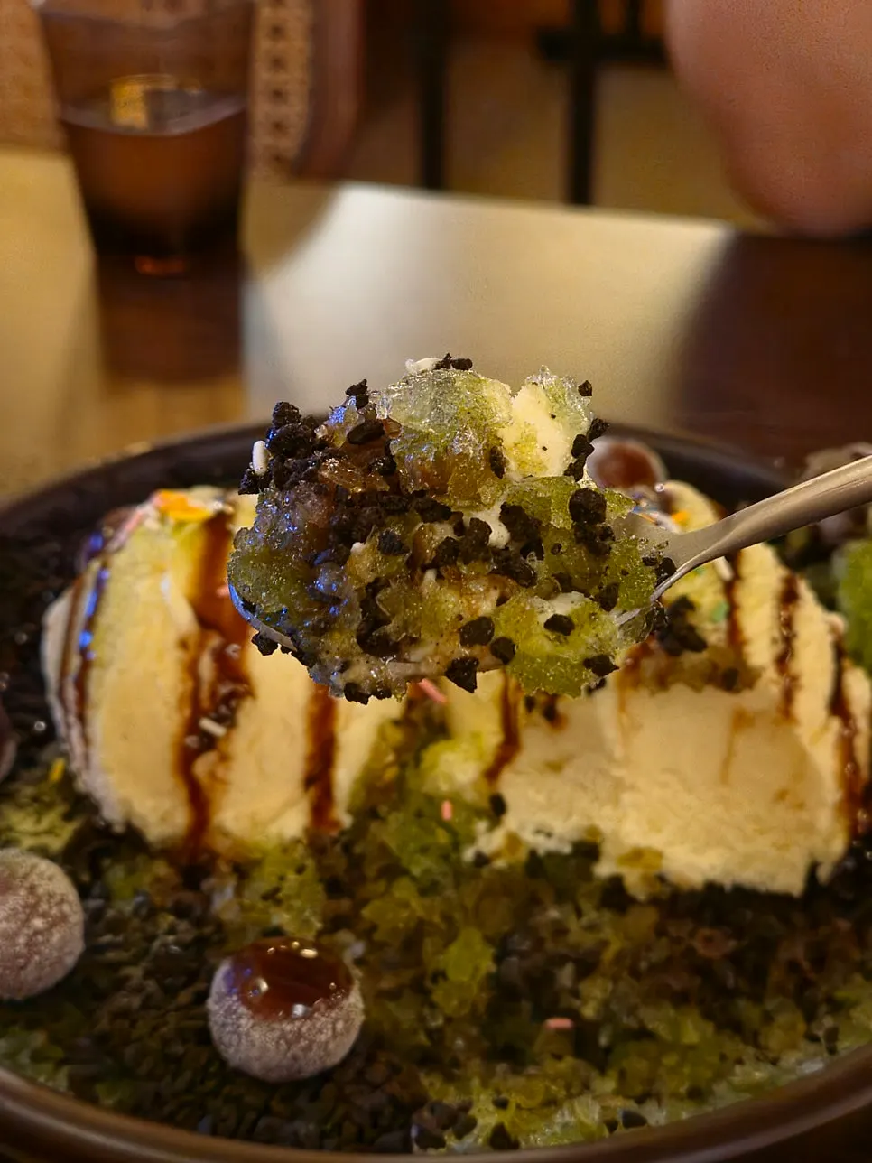 A bite of matcha bingsu mixed with chocolate balls and crispy topping